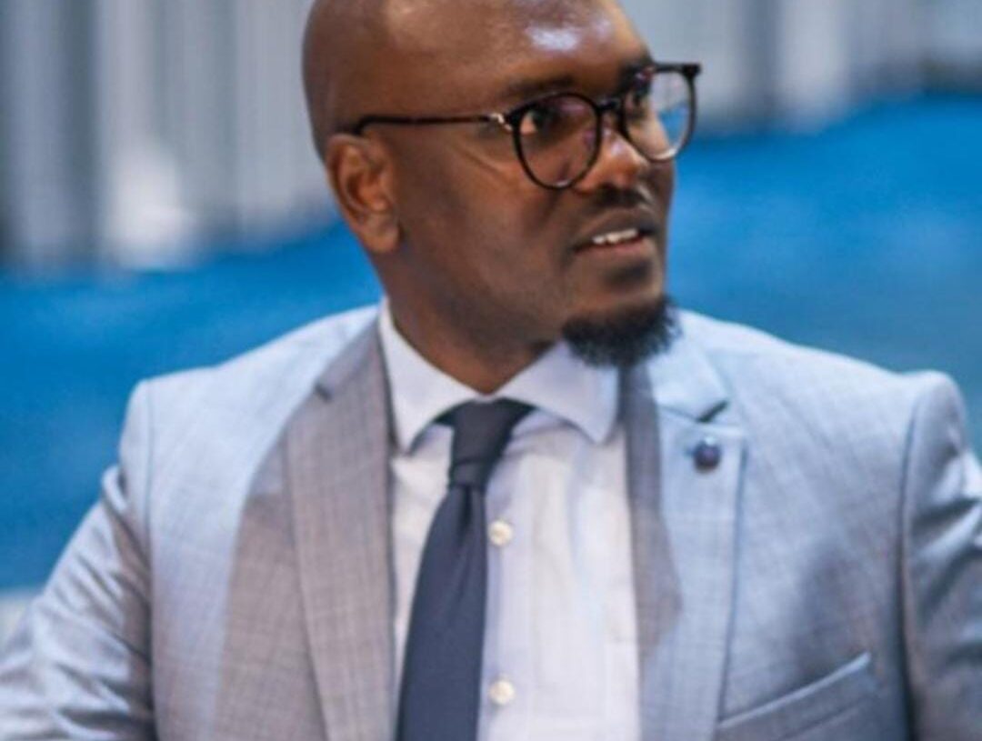 Man wearing glasses in grey suit