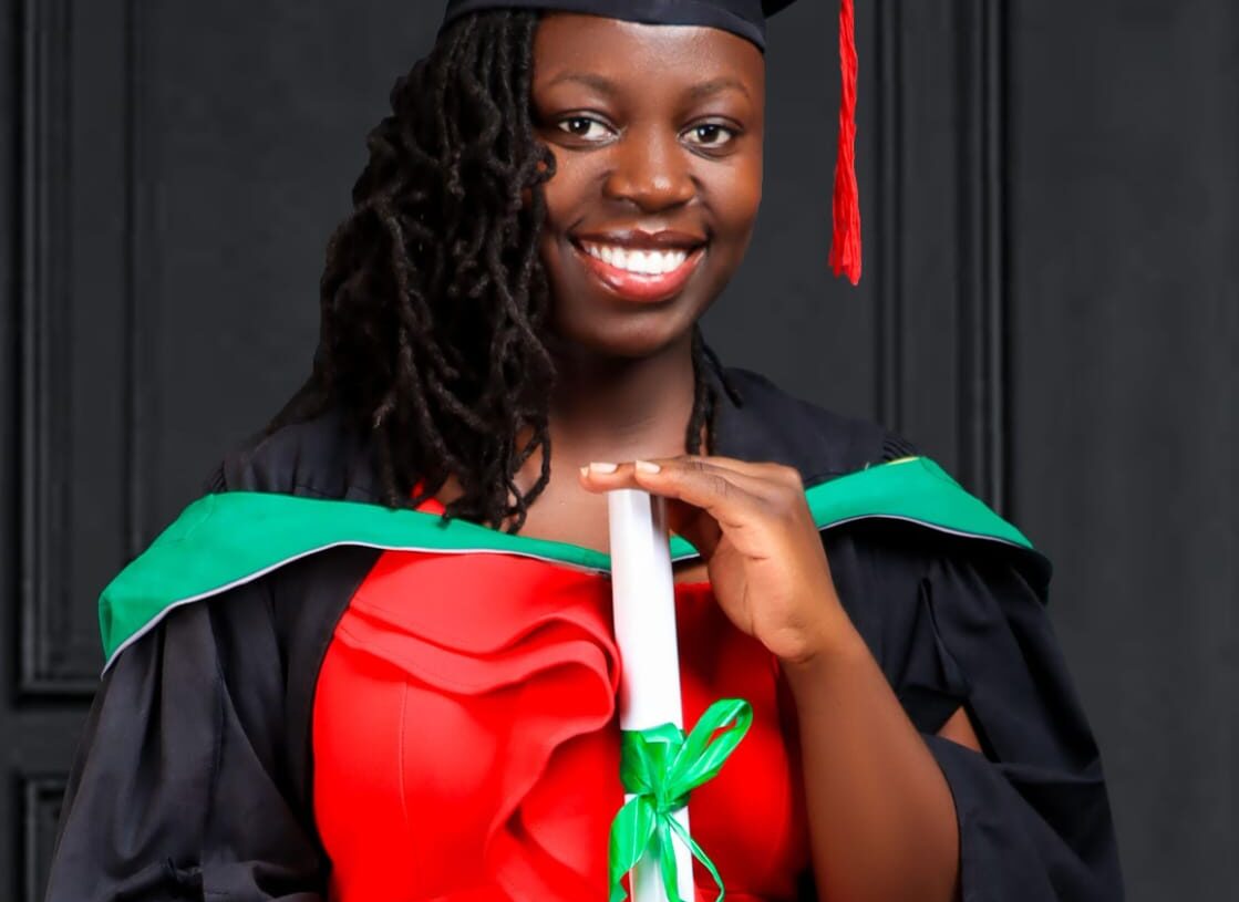 Lady graduated in graduation gown wearing red dress